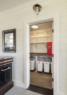 an open door leading to a kitchen with white walls