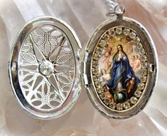 "- Our Lady Immaculate Conception . I created this unique and meaningful handmade locket designs in honor of Our Lady Immaculate Conception. Express your faith and devotion with this necklace, it's a very powerful piece and a true gift for yourself or someone special. . Created With: Beautiful large 35x26mm locket with image of Our Lady Immaculate Conception adorned with clear rhinestones. This pendant comes with chain. Materials: Rhinestones & Metal - All medals come with prayer . Please note: Immaculate Conception Of Mary, Handmade Locket Necklace, Handmade Locket, St Michael Archangel, Mary Immaculate, Michael Archangel, Locket Design, Archangel Michael, Saint Valentine