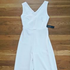 This Is A Beautiful White Jumpsuit. It Is Fitted And The Back Straps Are Crossed With A Cutout Below. Cute Summer Outfit For A Night Out. Would Make A Great Rehearsal Dinner Outfit Too Fitted White V-neck Jumpsuits And Rompers, Fitted White V-neck Jumpsuit, White Fitted V-neck Jumpsuit, White Fitted One-piece Jumpsuits And Rompers, Fitted White One-piece Jumpsuit, White Fitted One-piece Jumpsuit, White Fitted Jumpsuit, Blush Pink Jumpsuit, Rehearsal Dinner Outfit