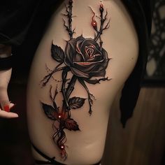 a woman's thigh with a rose tattoo on it