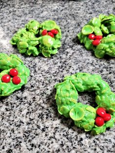 green pretzels decorated with red berries on a granite countertop, ready to be eaten