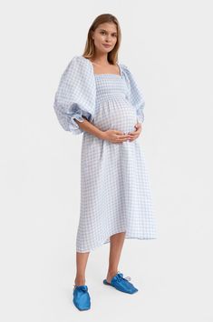 The bestselling Atlanta dress from Sleeper is a fashionista favorite. Perfect for brides' getting ready looks or mamas-to-be at their baby shower, this 100% linen dress features a square neckline and smocked bodice in a blue gingham print. The Atlanta midi's romantic, blouson sleeves can be worn on or off the shoulder. Comes with a matching hair scarf. Available in lavender, blue vichy and ivory silk. Maternity Dress With Smocked Bodice And Square Neck, Maternity Square Neck Dress For Spring, Fitted Square Neck Maternity Dress, Spring Maternity Dress With Square Neck, Summer Maternity Dress With Smocked Bodice, Linen Gingham Dress For Daywear, Gingham Linen Dress For Daywear, Spring Maternity Dress For Daywear, Maternity Dress Wedding Guest