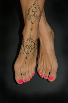 a woman's foot with tattoos on it