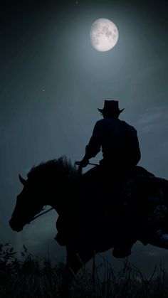 a man riding on the back of a horse under a full moon