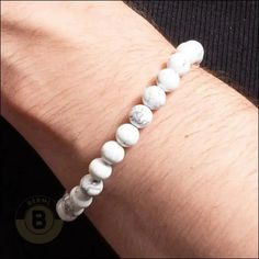 The Kincaid is a sleek statement piece that cuts through the noise. This cool, sharp white howlite isn’t flashy, but it packs a punch. It's like strapping on a shot of confidence, ready to tackle whatever life throws your way. Gear up and conquer! Specifications: Material: RockFinish: Polished Why do men's beaded bracelets never go out of style? Because they're the quintessential blend of fashion and ease. These bracelets are not just an accessory; they're an attitude. Our collection of gemstone Diamante Bracelet, Howlite Bracelet, Leather Choker Necklace, Pearl Choker Necklace, White Howlite, Natural Stone Bracelets, Jewelry For Men, Mens Beaded Bracelets, Chain Choker Necklace