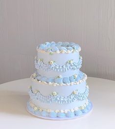 a three tiered blue and white wedding cake