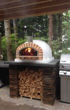 an outdoor pizza oven with firewood stacked in it