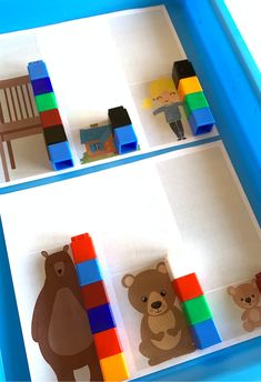 there are three pictures of different animals in the box with building blocks on it, and one has a bear