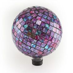 a colorful glass ball sitting on top of a black stand