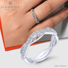 A flawless mixture of filigree detailing and magnificent .23ct pave diamonds create this one of a kind stackable ring. The contoured silhouette is crafted from polished 14k white gold for timeless elegance. LR6317W45JJ #FineJewelry#FashionJewelry#UniqueJewelry#GiftIdeas#UniqueGifts #DiamondJewelry #Jewelry #Mother'sDay#Ladies'Ring#DiamondStackable Modern Twist Open Band Diamond Ring, Elegant Wide Band Ring With Diamond Accents For Wedding, Elegant Wide Band Wedding Ring With Diamond Accents, Modern Stackable Rings In Diamond White, Elegant White Wide Band Ring, Elegant Stackable Wide Band Ring For Wedding, Designer Wedding Rings With Diamond Accents, Elegant White Wide Band Promise Ring, Designer White Wedding Rings