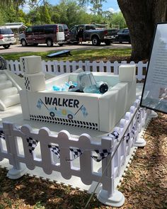 an outdoor hot tub in the shape of a car with a sign next to it