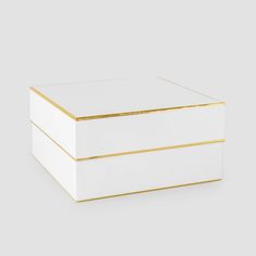 a white box with gold trim on the lid