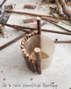 a bucket filled with lots of wood next to branches