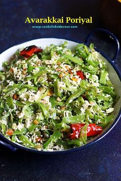 a white bowl filled with green vegetables on top of a blue tablecloth next to a bottle