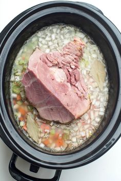 meat and vegetables in a slow cooker being cooked