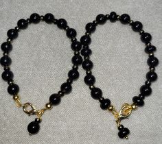 Beautiful 8mm round black Onyx beads with black and gold tone spacer beads.  Bracelet is 7 1/2 inches in length. US SHIPPING ONLY Gold Crystal Bracelet With Round Black Beads, Black Onyx Round Beads Bracelets, Black Onyx Stretch Bracelet With 8mm Beads, Black Onyx 8mm Beads Stretch Bracelet, Elegant Black Onyx Beads, Hand-strung Black Rosary Bracelet With Round Beads, Black Hand-strung Rosary Bracelet With Round Beads, Onyx Bead, Wedding Jewelry Sets