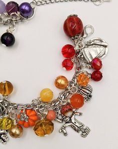 "- Autumn Charm Bracelet Stainless Steel Chain is adjustable from 6.5\" - 9\" with a lobster claw closure and extension chain The bracelet links are filled with a rainbow of glass and gem stone beads and crystals - really pretty. Mixed between the beads and gemstones are autumn themed silver and enamel charms. This is a great gift for anyone who loves the quirky symbols and bright colors of fall. I make these as they are ordered, so the processing time is 4 days. Your bracelet will be carefully Metal Beaded Dangle Charm Bracelet, Nickel Free Multicolor Charm Bracelet With Round Beads, Multicolor Charm Bracelet With Round Beads, Adjustable Multicolor Jewelry With Dangling Charms, Multicolor Beaded Metal Charm Bracelet, Nickel-free Multicolor Charm Bracelet For Jewelry Making, Nickel-free Multicolor Metal Charm Bracelet, Silver Bracelets With Lobster Clasp And Czech Glass, Nickel-free Multicolor Charm Bracelet With Round Beads