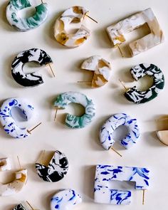 several different types of doughnuts with toothpicks stuck in them on a white surface