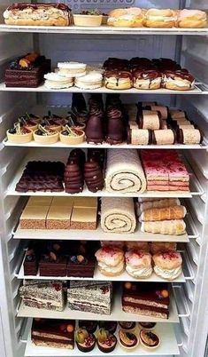 a refrigerator filled with lots of different types of cakes