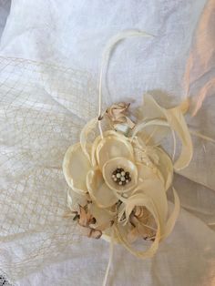 Fascinator Hat, Off-White Flower Bead Center, Vintage Beige Flowers, Vintage Curled & Goose Biot Feathers. Beige Bird Cage Veil, Hair Clip. This fascinator is fun to add to your hairdo for any special occasion or just to dress up your look. Great Wedding or Bridal Hair Decoration. Wear in your hair or on a hat for a glamorous touch. Clips Into Hair. Wear the Veil to the front or to the back. For other vintage and homemade items see: www.VeryVictorianStudio.etsy.com For sewing related items s Vintage Adjustable Beige Fascinator, Cream Flower Hair Accessories With Handmade Flowers, Elegant Handmade Cream Headpieces, Handmade Adjustable Cream Headpieces, Adjustable Handmade Cream Headpieces, Cream Hair Accessories With Handmade Flowers, Adjustable Cream Handmade Headpieces, Beige Mini Hat Headband For Weddings, Vintage Wedding Fascinator Headband