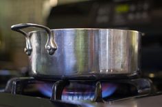 a pot sitting on top of a stove with a burner in the middle of it