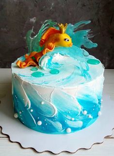 there is a cake that looks like a fish on top of the ocean waves and bubbles