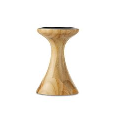 a wooden vase sitting on top of a white table