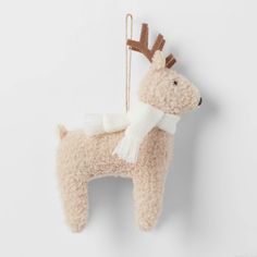 a stuffed animal with a scarf hanging from it's side on a white wall