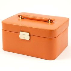 an orange suitcase is sitting on a white surface and has a gold lock at the top