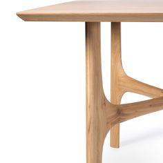 a wooden table with an unusual design on the top and bottom, against a white background