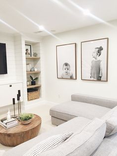 a living room filled with furniture and pictures on the wall