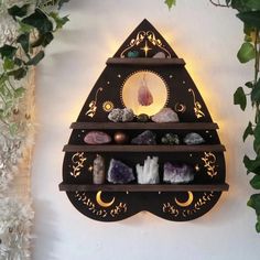 a shelf with rocks and candles on it