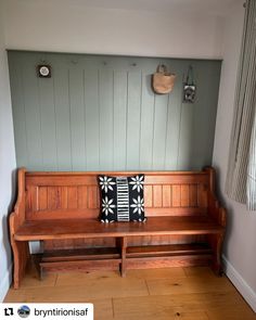 a wooden bench sitting in the corner of a room