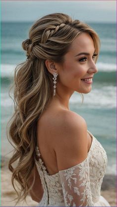 a woman with long hair wearing a wedding dress on the beach, smiling at the camera