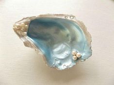 a blue shell with pearls on it