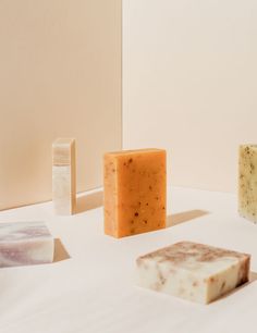 three soap bars sitting on top of a white table