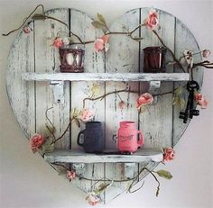 a heart shaped shelf with two mugs on it