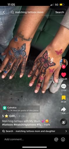 two hands with butterfly tattoos on them