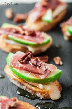 sandwiches with meat, cheese and apple slices on them are ready to be eaten in the oven