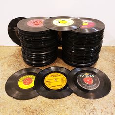 a stack of black records sitting on top of a counter