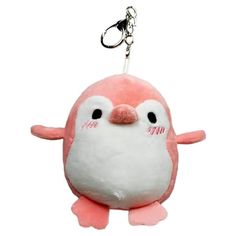 a pink and white penguin keychain hanging from a chain