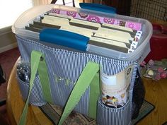 a large plastic container filled with files on top of a wooden table