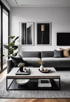 a living room with couches, tables and pictures on the wall above them in black and white