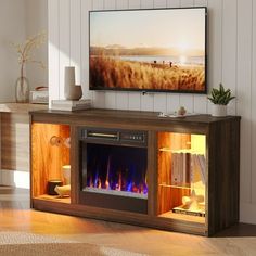 an entertainment center with a fireplace in the middle and a flat screen tv above it