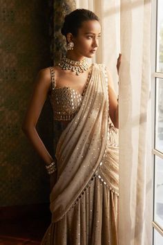 Light beige pre-draped saree with all over mirror embroidered buttis. Paired with a padded blouse with all over mirror, geometric embroidery. - Aza Fashions Beige Mirror, Vani Vats, Saree Gowns, Dhoti Saree, Cotton Sarees Handloom, Embroidery Mirror, Draped Saree, Ruffle Saree, Padded Blouse