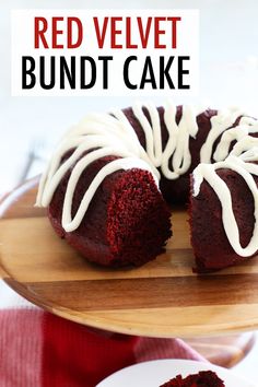 a red velvet bundt cake with white icing on a wooden plate next to a fork