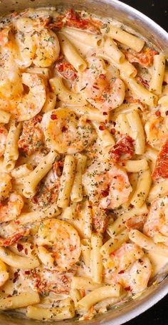 a pan filled with pasta and shrimp covered in sauce