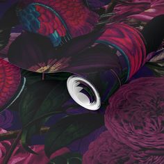 the wallpaper is very colorful and has many flowers on it, as well as a circular