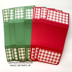 four red and green folders with checkered paper on them, each folded in different patterns