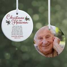 a christmas ornament hanging from a tree with a photo of an elderly man